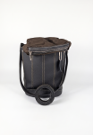 Black pebbled leather bucket bag featuring vertical contrast stitching, silver-tone hardware, and a dark brown inner fabric pouch resting on a white background.