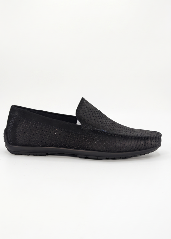 Profile shot of a black Shuclub slip-on shoe with intricate perforated patterns.