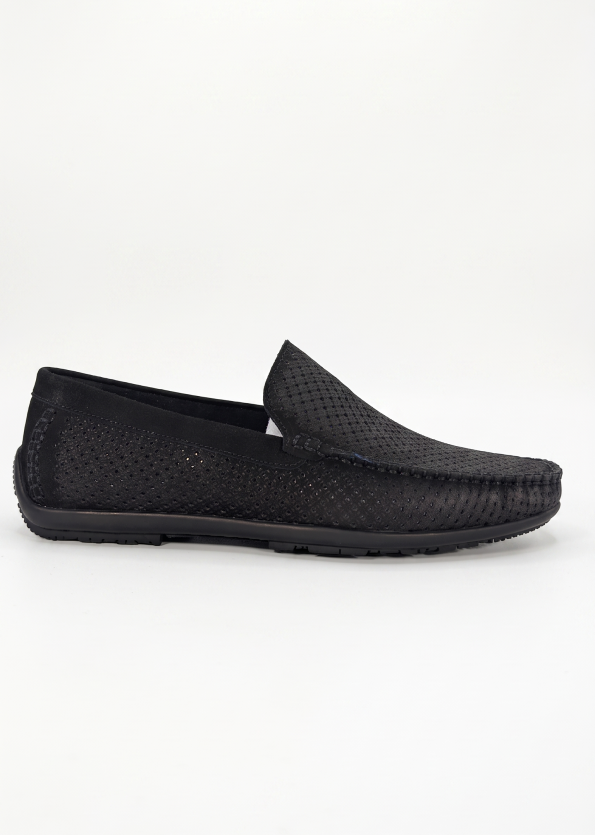 Profile shot of a black Shuclub slip-on shoe with intricate perforated patterns.