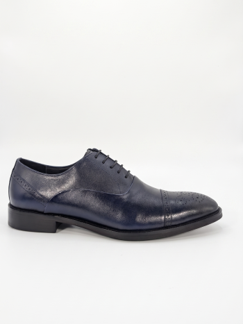 Side profile of a navy blue leather brogue oxford shoe