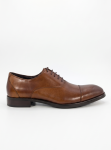 Side profile of a brown leather cap-toe Oxford shoe on a clean white background.