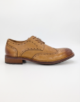 A side profile and top-down view of a hand-made men's tan leather brogue shoe featuring intricate decorative perforations, a reinforced heel, and a heavy-duty rubber lug sole for traction.