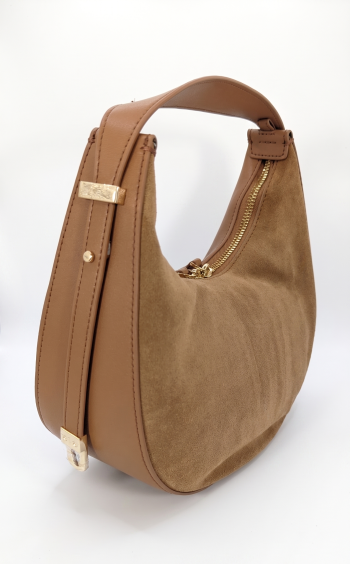 A cognac tan crescent-shaped hobo shoulder bag by SHUCLUB, featuring a rich textured suede body seamlessly paneled with smooth leather trim, dual gold-tone top zippers, and an adjustable side shoulder strap with polished gold hardware, shown from multiple product angles on a solid white background.